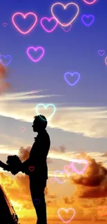 Silhouette of couple holding hands against a vibrant sunset sky.