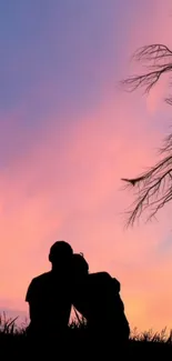 Silhouette of couple under pink and blue sunset sky.