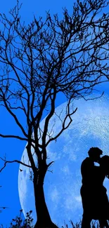 Silhouette couple kissing under a blue moonlit sky with a tree shadow.