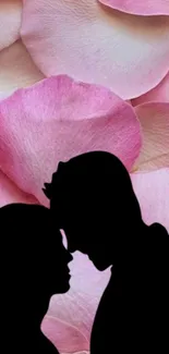 Romantic couple silhouette against pink petal background.