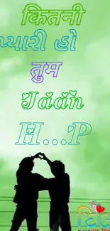 Silhouette of a couple on a green background with love text.