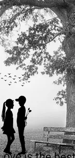 Romantic black and white wallpaper with a couple under a tree.