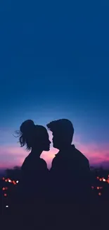 Silhouette of a couple against a colorful, vibrant sunset sky background.