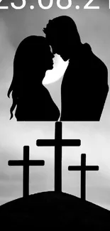 Romantic couple silhouette with sunset and crosses on a hill.