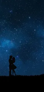 Silhouette of couple under a starry night sky.