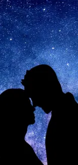 Silhouette of couple under starry night sky.