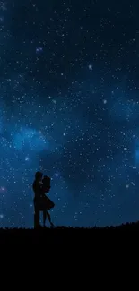 Silhouette couple under a starry night sky.