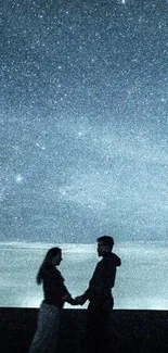 Silhouetted couple under a starry night sky, holding hands romantically.