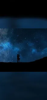 Silhouette couple embracing under a starry night sky.