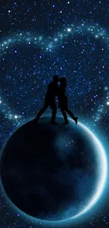 Couple silhouette on glowing planet against starry night sky.