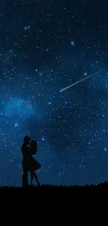 Silhouette of couple under a starry night sky with tree and dark blue background.