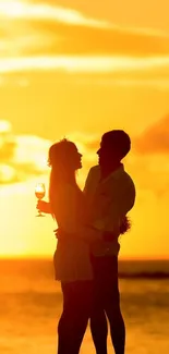 Romantic sunset beach with a couple silhouetted by the ocean.