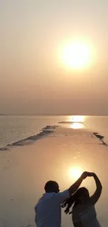 A couple dancing on a sunset-lit beach, creating a romantic silhouette against the horizon.