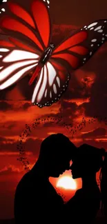 Romantic sunset with butterfly and couple silhouette.