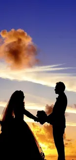 Silhouette of a romantic couple against a vibrant sunset sky.