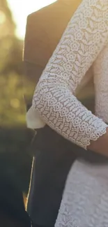 Romantic couple embracing at sunset with lace wedding dress.