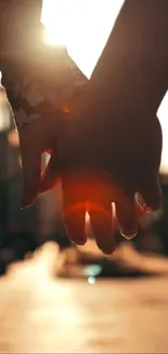 Romantic sunset with hands held together, warm and glowing.