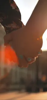 Handholding during sunset in the city, capturing warmth and intimacy.