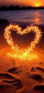 Heart-shaped lights on beach at sunset, romantic scene.