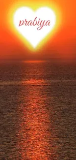 Sunset with heart-shaped glowing sun over the ocean.