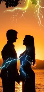 Silhouette of couple with sunset and lightning over a lake.