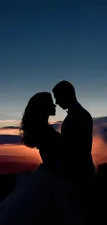 Romantic couple silhouette against a vibrant sunset sky.