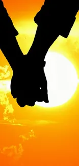 Silhouette of a couple holding hands against an orange sunset background.