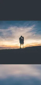 Silhouette of a couple embracing at sunset.