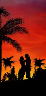 Silhouette couple against vibrant sunset with palm trees, creating romantic scenery.