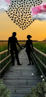 Couple silhouette at sunset with heart-shaped cloud art.