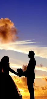 Silhouette of a couple at sunset sky, creating a romantic ambiance.