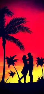 Romantic sunset with couple and palm trees in silhouette.