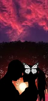 Silhouetted couple at sunset with butterfly and tree.