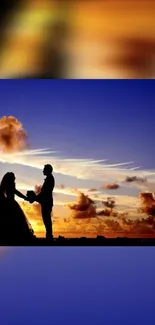 Silhouette of a couple against vibrant sunset sky.