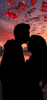 Romantic silhouette of couple against a vibrant sunset with love theme.