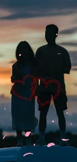 Couple silhouetted with heart lights on van roof at sunset.