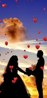Silhouette of a couple holding hands at sunset with vibrant sky.