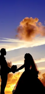 Silhouette of a couple at sunset under a colorful sky.