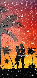 Silhouette of a couple under palm trees at sunset with vibrant orange sky.