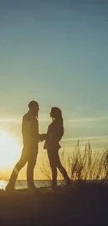 Silhouetted couple at sunset with beautiful sky.