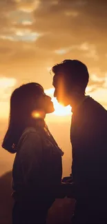 Silhouette of couple kissing at sunset, capturing a romantic moment.