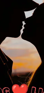 Silhouette of a couple kissing during a vibrant sunset.