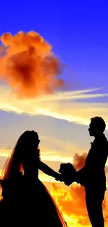 Silhouette of couple at a vibrant sunset with colorful clouds.