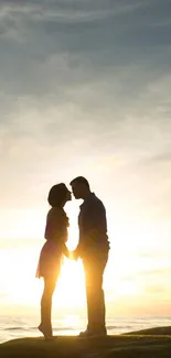 Romantic couple silhouette at sunset on a hill.