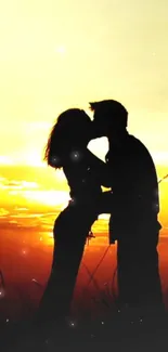 Silhouette of a couple kissing at sunset with glowing sky.