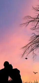 Silhouette couple under pink sunset with birds and tree.