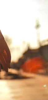 Silhouette of hands at sunset with warm tones and soft light.