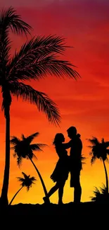 Couple silhouette at sunset under palm trees with vibrant orange sky.