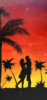 Silhouette of a couple by palm trees at sunset with vibrant orange sky.