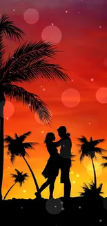 Silhouetted couple and palm trees at a vibrant sunset on mobile wallpaper.